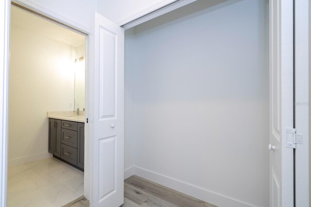 509 St Johns Ct, Poinciana, FL 34759 - bathroom featuring vanity, baseboards, and wood finished floors