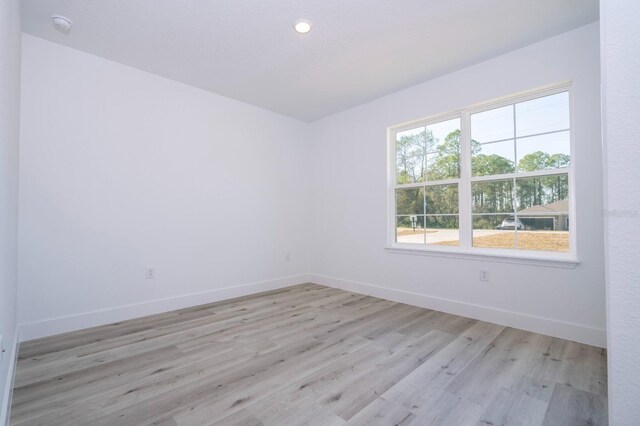 509 St Johns Ct, Poinciana, FL 34759 - unfurnished room with baseboards, light wood-type flooring, and a smoke detector