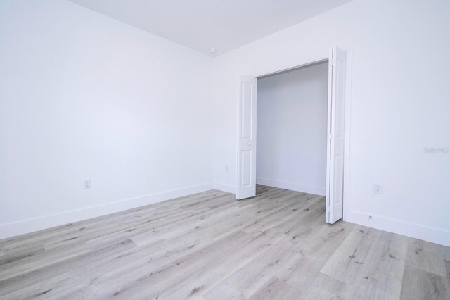 509 St Johns Ct, Poinciana, FL 34759 - unfurnished bedroom with wood finished floors and baseboards