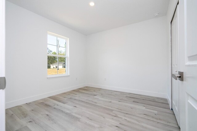 509 St Johns Ct, Poinciana, FL 34759 - spare room with light wood finished floors, baseboards, a smoke detector, and recessed lighting