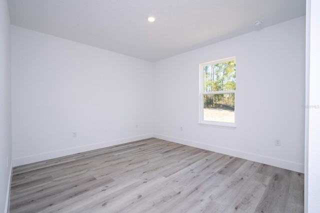 509 St Johns Ct, Poinciana, FL 34759 - spare room featuring light wood-type flooring, baseboards, recessed lighting, and a smoke detector
