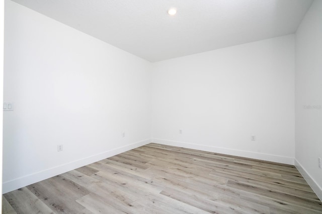 509 St Johns Ct, Poinciana, FL 34759 - empty room with light wood-style floors, baseboards, and recessed lighting