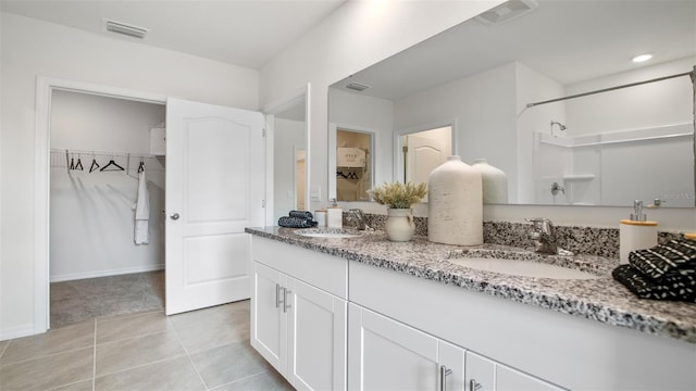 1495 Fountain View St, Ormond Beach, FL 32174 - bathroom with double vanity, tile patterned flooring, a spacious closet, and a shower