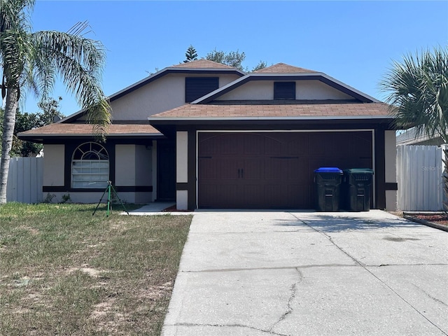 6554 Meritmoor Cir, Orlando, FL 32818 - ranch-style home featuring stucco siding, an attached garage, concrete driveway, and roof with shingles