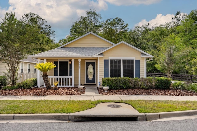 3832 NW 27th St, Gainesville, FL 32605 - view of front of house featuring covered porch and a shingled roof