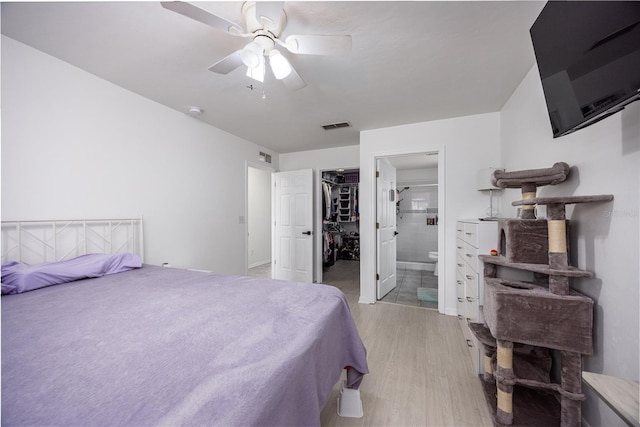 3832 NW 27th St, Gainesville, FL 32605 - bedroom with light wood-type flooring, a spacious closet, connected bathroom, a ceiling fan, and a closet