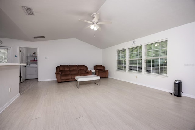 3832 NW 27th St, Gainesville, FL 32605 - sitting room with ceiling fan, lofted ceiling, wood finished floors, baseboards, and washer / clothes dryer