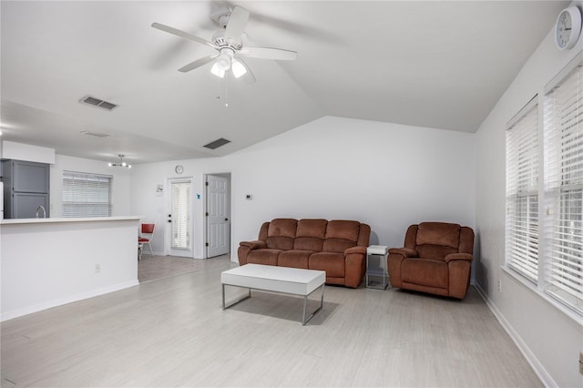 3832 NW 27th St, Gainesville, FL 32605 - living room with light wood-style floors, lofted ceiling, ceiling fan, and baseboards