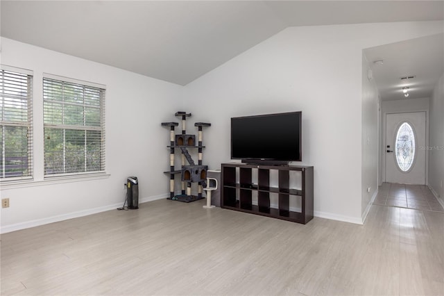 3832 NW 27th St, Gainesville, FL 32605 - living area with vaulted ceiling, wood finished floors, and baseboards