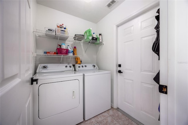 3832 NW 27th St, Gainesville, FL 32605 - laundry area with independent washer and dryer and light tile patterned flooring