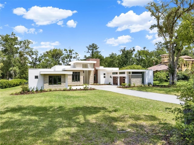 7615 SE 12th Cir, Ocala, FL 34480 - contemporary home with driveway, stucco siding, a front yard, and stone siding