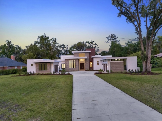 7615 SE 12th Cir, Ocala, FL 34480 - contemporary home featuring driveway, a front lawn, and stucco siding