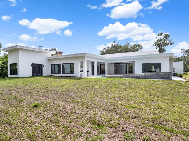 7615 SE 12th Cir, Ocala, FL 34480 - rear view of property with stucco siding and a yard