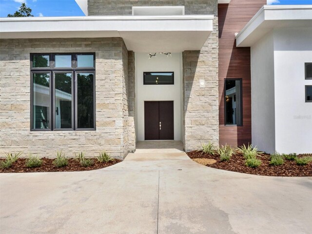 7615 SE 12th Cir, Ocala, FL 34480 - property entrance with stone siding and stucco siding