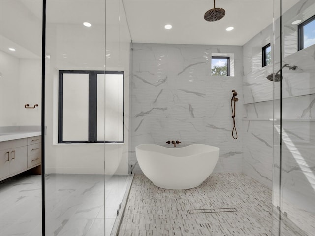 7615 SE 12th Cir, Ocala, FL 34480 - bathroom with marble tiled floors, a marble finish shower, vanity, recessed lighting, and a freestanding tub