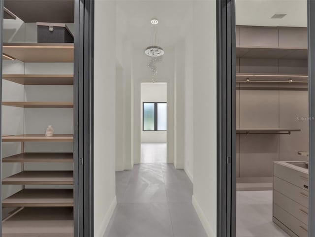 7615 SE 12th Cir, Ocala, FL 34480 - hallway with baseboards, light tile patterned floors, and a sink