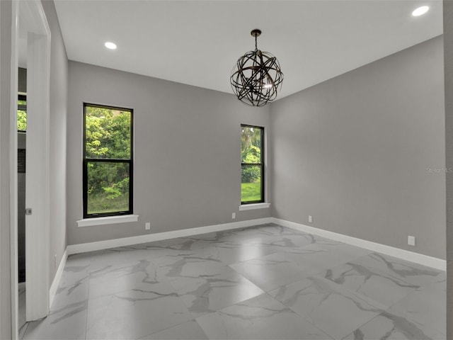 7615 SE 12th Cir, Ocala, FL 34480 - spare room with baseboards, recessed lighting, marble finish floors, and a chandelier