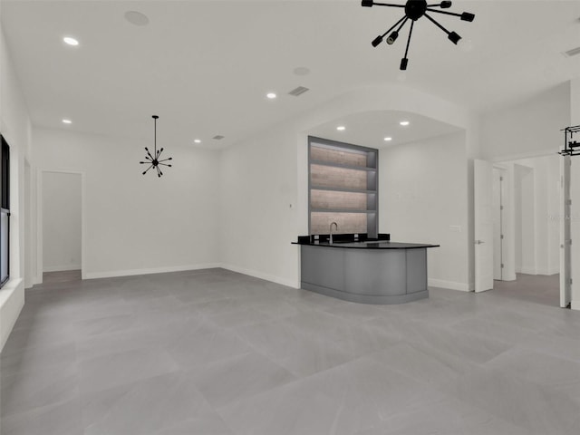 7615 SE 12th Cir, Ocala, FL 34480 - unfurnished living room with a chandelier, recessed lighting, baseboards, and arched walkways