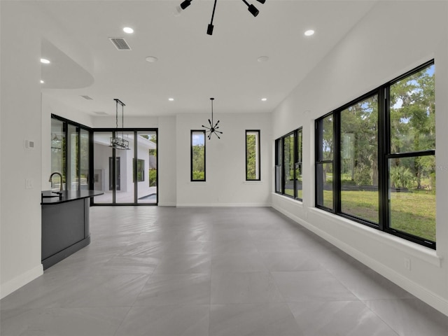 7615 SE 12th Cir, Ocala, FL 34480 - unfurnished living room with recessed lighting, baseboards, a chandelier, and a sink
