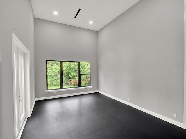 7615 SE 12th Cir, Ocala, FL 34480 - unfurnished room featuring baseboards, a high ceiling, and recessed lighting