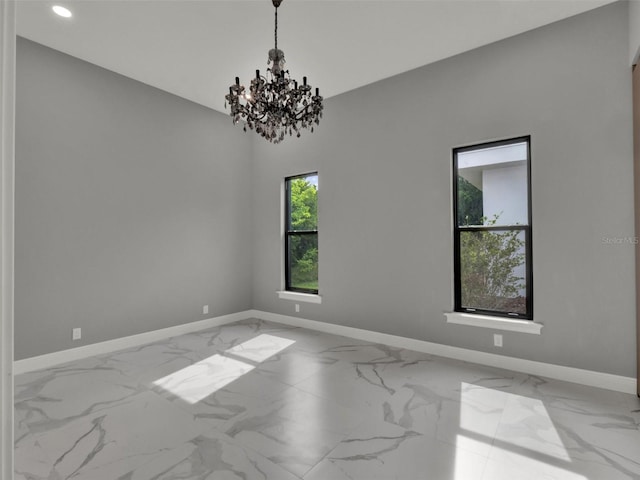 7615 SE 12th Cir, Ocala, FL 34480 - empty room with marble look tiles, baseboards, a chandelier, and recessed lighting