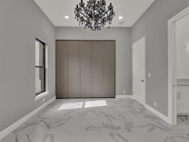 7615 SE 12th Cir, Ocala, FL 34480 - unfurnished bedroom featuring light marble finish floors, baseboards, a closet, a chandelier, and recessed lighting