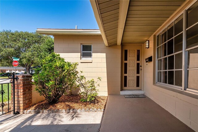 3121 Thistlehill Dr, Winter Park, FL 32792 - doorway to property featuring concrete block siding