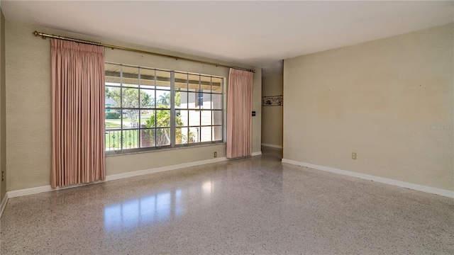 3121 Thistlehill Dr, Winter Park, FL 32792 - spare room featuring speckle patterned floor and baseboards