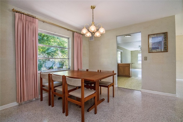 3121 Thistlehill Dr, Winter Park, FL 32792 - dining room with speckled floor, a chandelier, healthy amount of natural light, and baseboards