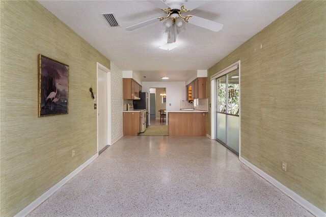3121 Thistlehill Dr, Winter Park, FL 32792 - hallway with baseboards, a textured ceiling, dark aggregate flooring, and a sink