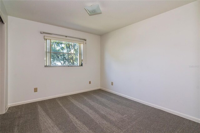 3121 Thistlehill Dr, Winter Park, FL 32792 - spare room featuring dark carpet and baseboards