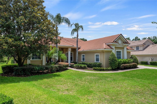 8475 Eagles Loop Cir, Windermere, FL 34786 - view of front facade with stucco siding, a front lawn, and a tiled roof