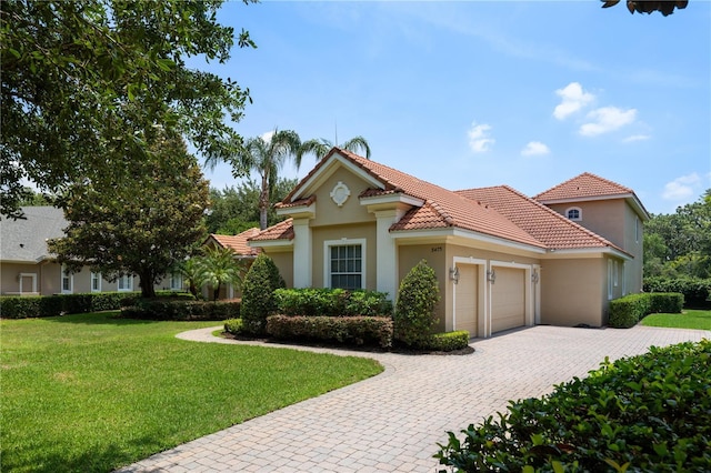 8475 Eagles Loop Cir, Windermere, FL 34786 - mediterranean / spanish home featuring an attached garage, stucco siding, a front lawn, and decorative driveway