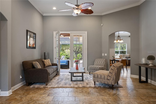 8475 Eagles Loop Cir, Windermere, FL 34786 - living area with stone tile floors, arched walkways, baseboards, ceiling fan, and ornamental molding