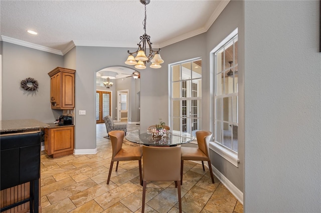 8475 Eagles Loop Cir, Windermere, FL 34786 - dining room featuring a chandelier, arched walkways, ornamental molding, baseboards, and stone tile flooring