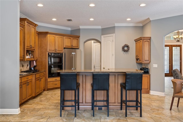 8475 Eagles Loop Cir, Windermere, FL 34786 - kitchen featuring arched walkways, high end fridge, a center island with sink, a kitchen bar, and recessed lighting