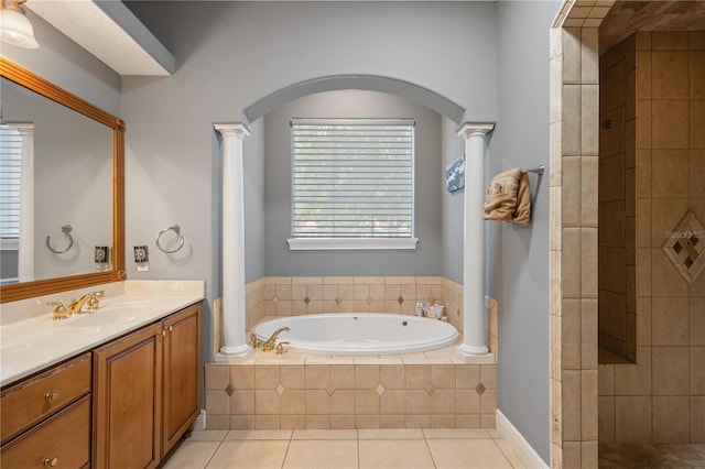 8475 Eagles Loop Cir, Windermere, FL 34786 - bathroom with a bath, vanity, ornate columns, tile patterned flooring, and tiled shower