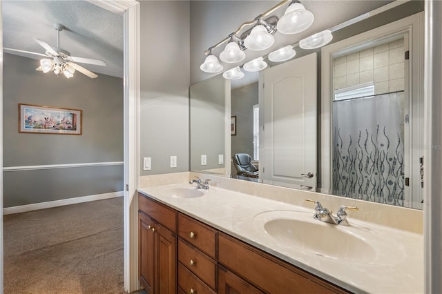 8475 Eagles Loop Cir, Windermere, FL 34786 - full bath with double vanity, ceiling fan, a textured ceiling, and baseboards