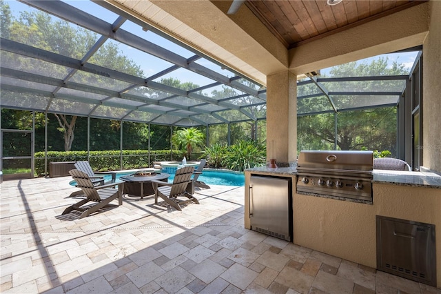 8475 Eagles Loop Cir, Windermere, FL 34786 - view of patio / terrace with a pool with connected hot tub, glass enclosure, and an outdoor fire pit
