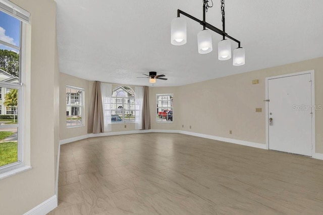 2040 Royal Bay Blvd Unit 31, Kissimmee, FL 34746 - unfurnished living room with ceiling fan and baseboards