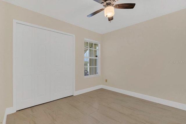 2040 Royal Bay Blvd Unit 31, Kissimmee, FL 34746 - unfurnished bedroom with baseboards, a closet, and a ceiling fan