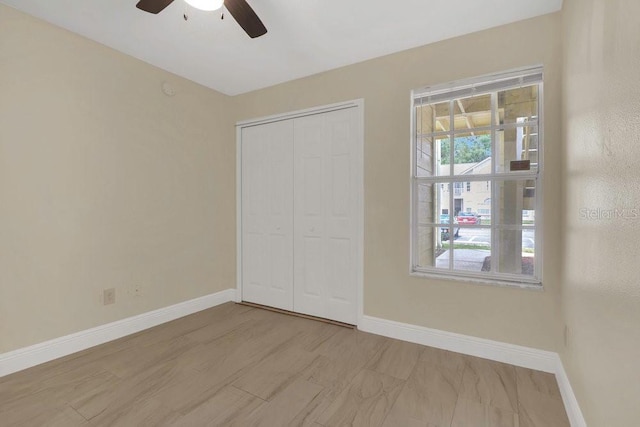 2040 Royal Bay Blvd Unit 31, Kissimmee, FL 34746 - unfurnished bedroom featuring baseboards, a closet, and a ceiling fan