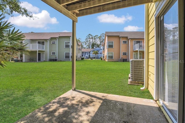 2040 Royal Bay Blvd Unit 31, Kissimmee, FL 34746 - view of green lawn featuring a residential view and central air condition unit