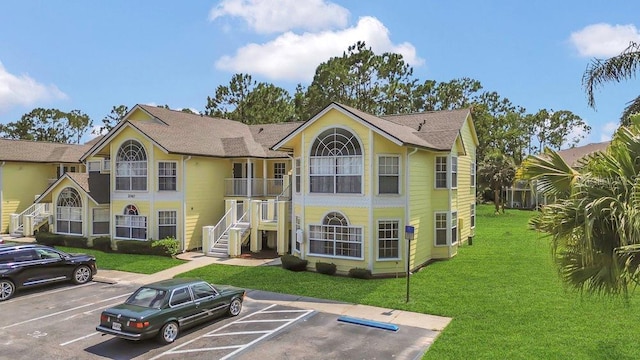 2040 Royal Bay Blvd Unit 31, Kissimmee, FL 34746 - view of front facade with uncovered parking, a front yard, and stairs