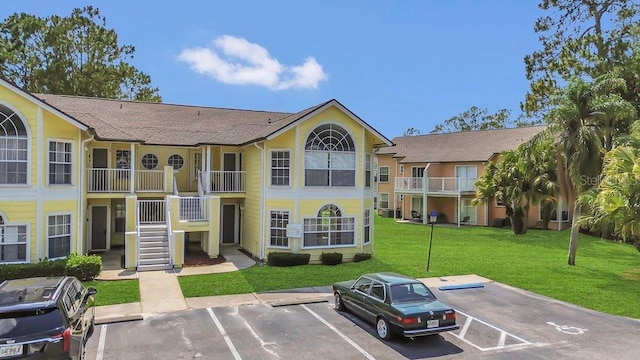 2040 Royal Bay Blvd Unit 31, Kissimmee, FL 34746 - view of building exterior with uncovered parking and stairway