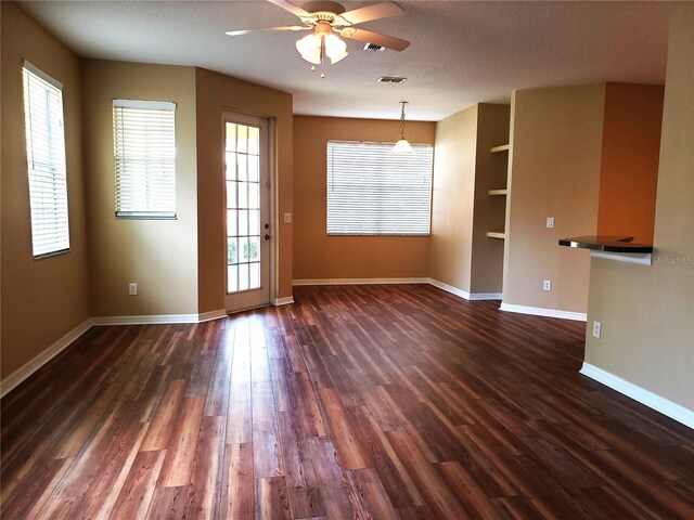 3658 Oakdale Cir Unit 100, Oviedo, FL 32765 - unfurnished room featuring plenty of natural light, ceiling fan, baseboards, and dark wood-style floors