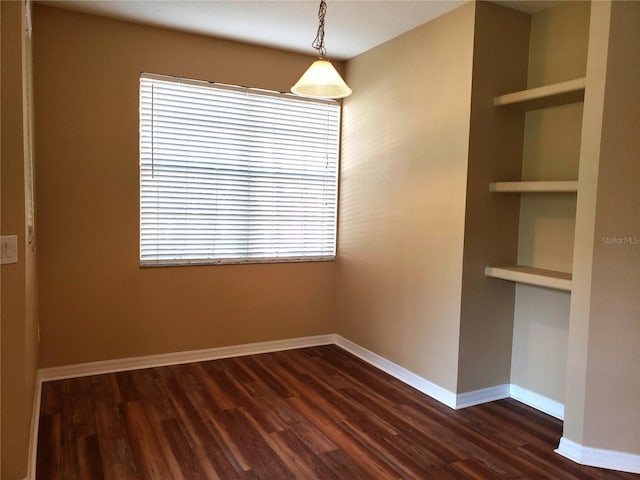 3658 Oakdale Cir Unit 100, Oviedo, FL 32765 - unfurnished dining area featuring dark wood-style flooring and baseboards