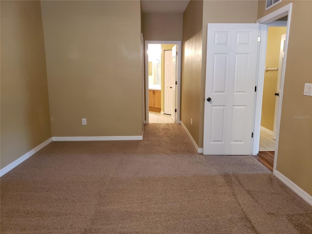 3658 Oakdale Cir Unit 100, Oviedo, FL 32765 - unfurnished bedroom with carpet, baseboards, and connected bathroom