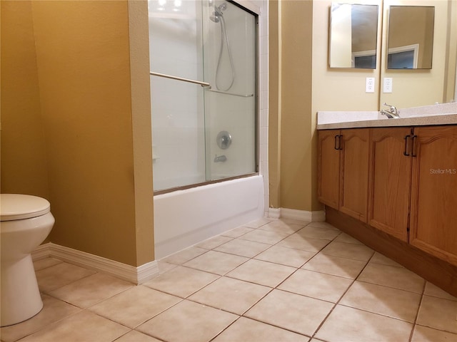 3658 Oakdale Cir Unit 100, Oviedo, FL 32765 - bathroom featuring toilet, tile patterned floors, vanity, combined bath / shower with glass door, and baseboards