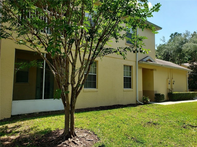 3658 Oakdale Cir Unit 100, Oviedo, FL 32765 - view of side of property featuring stucco siding and a lawn